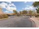 Gated community entrance with landscaping and a paved road at 3357 Sheep Canyon St, Las Vegas, NV 89122