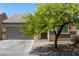 Single-story house with a gray garage door and landscaping at 3357 Sheep Canyon St, Las Vegas, NV 89122