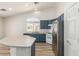 Modern kitchen with blue cabinetry and an island at 3357 Sheep Canyon St, Las Vegas, NV 89122