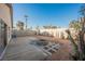 Spacious backyard featuring a concrete patio area, a stone fire pit, and privacy wall at 353 Keating St, Henderson, NV 89074