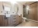 Modern bathroom featuring a double vanity with sleek countertops and a glass-enclosed shower at 353 Keating St, Henderson, NV 89074