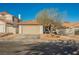 Single-story home with a two-car garage and desert-style landscaping in the front yard at 353 Keating St, Henderson, NV 89074