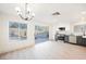 Open-concept kitchen and dining area with stainless steel appliances and a large sliding glass door to the backyard at 353 Keating St, Henderson, NV 89074