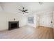 Bright living room featuring a fireplace, ceiling fan, and wood-look floors at 353 Keating St, Henderson, NV 89074