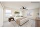 Staged main bedroom featuring neutral tones, plush carpet, and large windows for plenty of natural light at 353 Keating St, Henderson, NV 89074