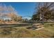 Community playground with slides, climbing structures, and picnic benches nestled among mature trees for outdoor fun at 353 Keating St, Henderson, NV 89074