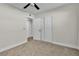 Bedroom featuring neutral walls and carpet, a ceiling fan, and a double-door closet at 3700 San Angelo Ave, Las Vegas, NV 89102