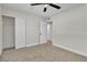 Bedroom featuring neutral walls and carpet, a ceiling fan, and a double-door closet at 3700 San Angelo Ave, Las Vegas, NV 89102