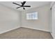 Neutral bedroom features a ceiling fan, window with blinds, and neutral carpet flooring at 3700 San Angelo Ave, Las Vegas, NV 89102