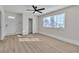 A sunlit bedroom with hardwood floors, a ceiling fan, and a large window for ample natural light at 3700 San Angelo Ave, Las Vegas, NV 89102