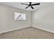 Neutral bedroom features a ceiling fan, window with blinds, and neutral carpet flooring at 3700 San Angelo Ave, Las Vegas, NV 89102