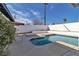 A refreshing swimming pool is surrounded by a white brick fence, and concrete decking at 3700 San Angelo Ave, Las Vegas, NV 89102