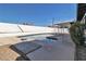 A refreshing swimming pool is surrounded by a white brick fence, and concrete decking at 3700 San Angelo Ave, Las Vegas, NV 89102