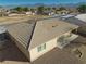 Single story tan home featuring a covered patio, desert landscaping, and brown tile roof at 3714 Mount Charleston Dr, Pahrump, NV 89048