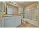 Bathroom featuring white vanity, framed mirror, tiled floors, and a shower/tub combination with sliding glass doors at 3714 Mount Charleston Dr, Pahrump, NV 89048