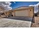 Home's exterior featuring a two-car garage and a driveway with desert landscaping at 3714 Mount Charleston Dr, Pahrump, NV 89048