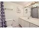 Clean bathroom featuring a toilet, vanity with sink, and geometric patterned shower curtain at 3932 Voxna St, Las Vegas, NV 89119