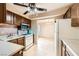 Functional kitchen with classic cabinetry, essential appliances, and a view into the adjoining bonus room at 3932 Voxna St, Las Vegas, NV 89119