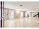 Bright living room with tile flooring, decorative mirror, and sheer curtains, creating an airy atmosphere at 3932 Voxna St, Las Vegas, NV 89119