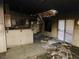 View of a damaged living room featuring a sliding glass door and kitchen bar at 4225 Seth Dr, North Las Vegas, NV 89032