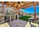 Inviting backyard bar area with a thatched roof, bar seating, and scenic backyard views at 4424 Shady Hollow Ave, North Las Vegas, NV 89031