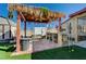 Outdoor living space with a thatched roof bar and patio seating for entertaining and relaxing at 4424 Shady Hollow Ave, North Las Vegas, NV 89031