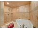 Luxurious bathroom showcasing a soaking tub, tile walls, and a walk-in shower at 4424 Shady Hollow Ave, North Las Vegas, NV 89031