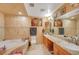 Beautiful bathroom with dual sinks, soaking tub, and tile surround at 4424 Shady Hollow Ave, North Las Vegas, NV 89031