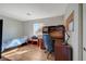 Bedroom with hardwood flooring includes a desk area and ample natural light, perfect for study or relaxation at 4424 Shady Hollow Ave, North Las Vegas, NV 89031