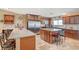 Spacious kitchen features granite countertops, stainless steel appliances, and travertine floors at 4424 Shady Hollow Ave, North Las Vegas, NV 89031