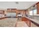 Well-lit kitchen featuring stainless steel appliances, granite countertops, and wooden cabinetry at 4424 Shady Hollow Ave, North Las Vegas, NV 89031