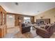 Comfortable living room featuring a fireplace, tile floors, and ample natural light from the large window at 4424 Shady Hollow Ave, North Las Vegas, NV 89031