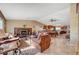 Open-concept living room boasts travertine tile, fireplace and connects to the kitchen at 4424 Shady Hollow Ave, North Las Vegas, NV 89031