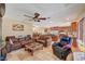 Open-concept living room features comfortable furniture, travertine floors, and natural light at 4424 Shady Hollow Ave, North Las Vegas, NV 89031