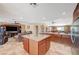 Open concept living space featuring travertine flooring, a kitchen island, and a spacious seating area at 4424 Shady Hollow Ave, North Las Vegas, NV 89031