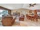 Spacious living room with an open layout, fireplace, and comfortable seating adjacent to the dining area at 4424 Shady Hollow Ave, North Las Vegas, NV 89031