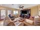 Cozy living room with comfortable leather seating, ceiling fan, and a large entertainment center at 4424 Shady Hollow Ave, North Las Vegas, NV 89031