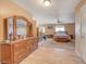 Large main bedroom with travertine floors, ceiling fan, and sitting area with natural light at 4424 Shady Hollow Ave, North Las Vegas, NV 89031