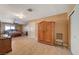 Bright main bedroom features an armoire, ceiling fan, double doors, and neutral paint at 4424 Shady Hollow Ave, North Las Vegas, NV 89031