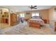 Open-concept main bedroom with natural light, ceiling fan, exercise equipment, and en-suite bathroom at 4424 Shady Hollow Ave, North Las Vegas, NV 89031