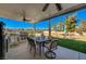 Outdoor kitchen featuring a built-in grill, dining area, and covered patio for year-round enjoyment at 4424 Shady Hollow Ave, North Las Vegas, NV 89031