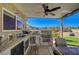 Inviting outdoor kitchen boasts a built-in grill, sink, and dining area, perfect for entertaining guests at 4424 Shady Hollow Ave, North Las Vegas, NV 89031