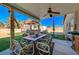 Inviting covered patio featuring a dining area, ceiling fan, and outdoor grill with backyard views at 4424 Shady Hollow Ave, North Las Vegas, NV 89031