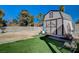 Well-maintained shed in the backyard with double doors and fresh green lawn at 4424 Shady Hollow Ave, North Las Vegas, NV 89031