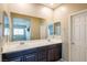 Double vanity bathroom with dark wood cabinets and large mirror at 4495 Violet Flowers St # 2046, North Las Vegas, NV 89031