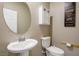 Small bathroom with pedestal sink, toilet and decorative mirror at 4495 Violet Flowers St # 2046, North Las Vegas, NV 89031