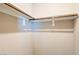 Empty closet with wood hanging rods and neutral walls at 4495 Violet Flowers St # 2046, North Las Vegas, NV 89031