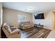 Bright living room featuring hardwood floors and comfy reclining sofas at 4495 Violet Flowers St # 2046, North Las Vegas, NV 89031