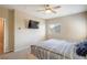 Main bedroom with large bed, ceiling fan, and wall-mounted TV at 4495 Violet Flowers St # 2046, North Las Vegas, NV 89031