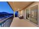 A covered balcony with sliding door access offers seating and views of the mountains and backyard at 4499 Amazing View St, Las Vegas, NV 89129